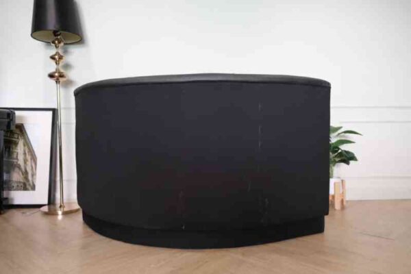 Curved leather sofa, beautiful shadow, wooden frame, black color.