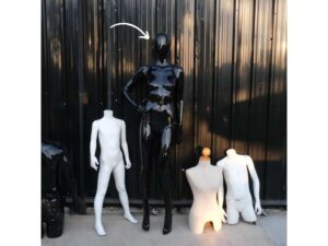 The mannequin showcases a full-body black women's shirt