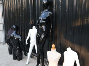 The mannequin showcases a full-body black women's shirt
