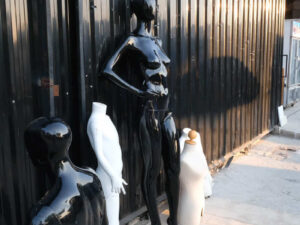 The mannequin showcases a full-body black women's shirt