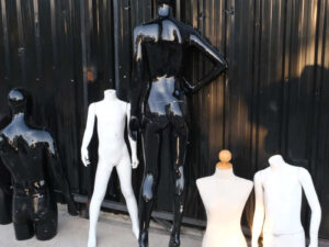 The mannequin showcases a full-body black women's shirt
