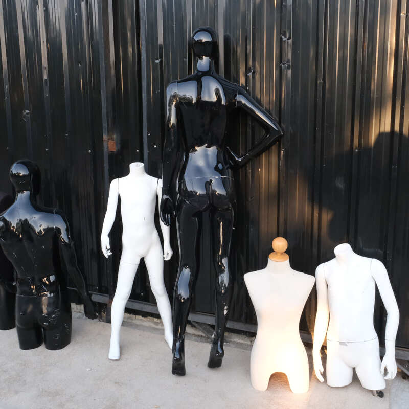 The mannequin showcases a full-body black women's shirt