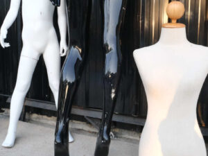 The mannequin showcases a full-body black women's shirt