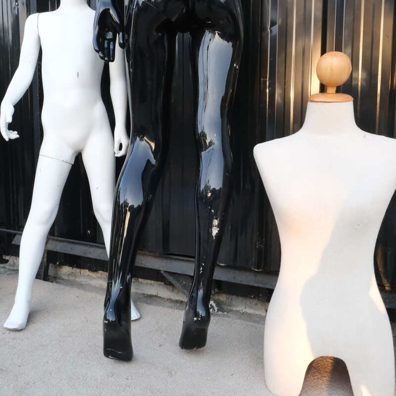 The mannequin showcases a full-body black women's shirt