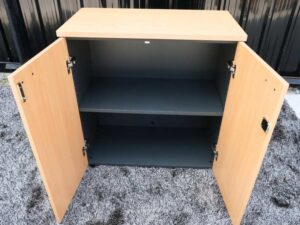 File cabinet with 2 doors, gray color, light wood top, Rockworth brand.