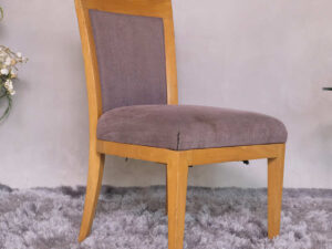 Wooden chair with purple fabric cushion, beautiful design.