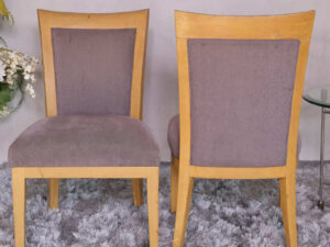 Wooden chair with purple fabric cushion, beautiful design.
