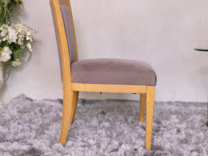 Wooden chair with purple fabric cushion, beautiful design.