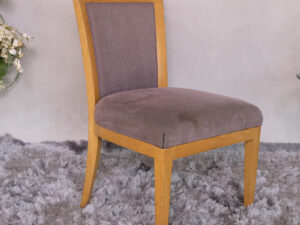 Wooden chair with purple fabric cushion, beautiful design.