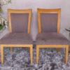 Wooden chair with purple fabric cushion, beautiful design.