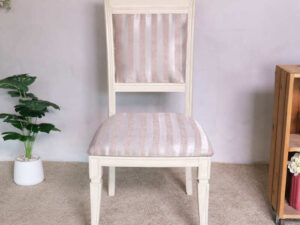 Wooden chair, purple cloth cushion with straight pattern, beautiful frame, cushioned backrest.