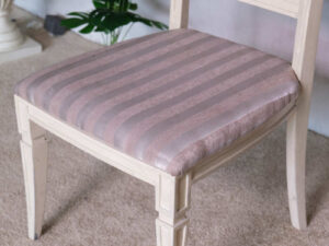Wooden chair, purple cloth cushion with straight pattern, beautiful frame, cushioned backrest.