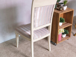 Wooden chair, purple cloth cushion with straight pattern, beautiful frame, cushioned backrest.