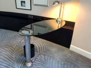 Hotel work desk, glass top, 10 mm thick, stainless steel legs.