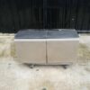 Multi-purpose storage cabinet, low shape, made from wood with stainless steel panels on the outside.