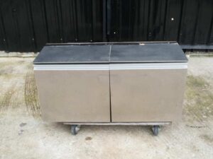 Multi-purpose storage cabinet, low shape, made from wood with stainless steel panels on the outside.