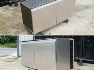 Multi-purpose storage cabinet, low shape, made from wood with stainless steel panels on the outside.