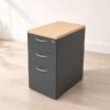 Gray wooden filing cabinet with 3 drawers, cream colored wood top. (no wheels/no key)