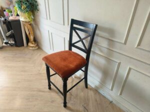 Wooden chair with brown fabric cushion, beautiful design.
