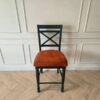 Wooden chair with brown fabric cushion, beautiful design.