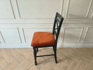 Wooden chair with brown fabric cushion, beautiful design.