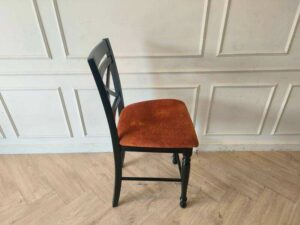 Wooden chair with brown fabric cushion, beautiful design.