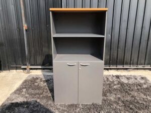 Tall file cabinet, 2 doors, gray color, wooden top.