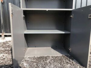 Tall file cabinet, 2 doors, gray color, wooden top.