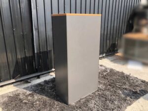 Tall file cabinet, 2 doors, gray color, wooden top.