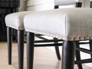Gray silk leather chair, wooden frame, riveted backrest and seat.
