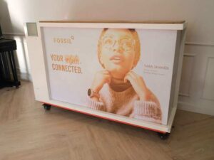 Orange and white counter with 3 storage doors at the back.