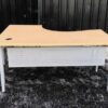 L-shaped work desk, gray steel frame, wooden top.