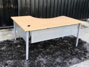 L-shaped work desk, gray steel frame, wooden top.