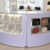 Curved glass jewelry showcase cabinet in purple color, without glass door.
