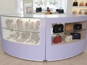 Curved glass jewelry showcase cabinet in purple color, without glass door.