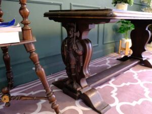 Multi-purpose table wood carving European work comes from Germany.
