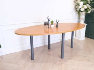 Conference table, steel legs, wooden top, oval shape.