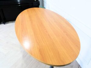 Conference table, steel legs, wooden top, oval shape.