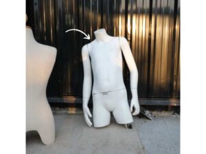 Boys' white shirt displayed on mannequin.