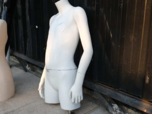 Boys' white shirt displayed on mannequin.