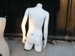 Boys' white shirt displayed on mannequin.
