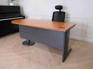 Wooden desk with steel legs, curved front, one side, brand Rockworth._