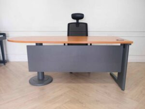 Wooden desk with steel legs, curved front, one side, brand Rockworth._