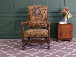 Carved chair, Louis style, fabric cushion with feminine floral pattern. European work comes from Germany.