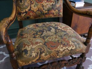 Carved chair, Louis style, fabric cushion with feminine floral pattern. European work comes from Germany.