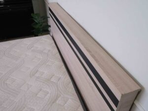 Bed brand T-DA furniture, light colored wooden frame. Black cut lines at the head of the bed, minimalist, 5 feet