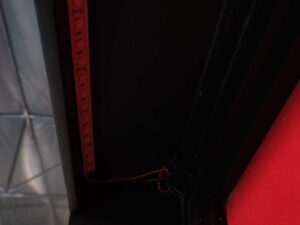Product shelf Without shelves (black-red), wooden frame, with storage drawers.