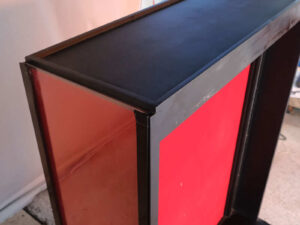 Product shelf Without shelves (black-red), wooden frame, with storage drawers.