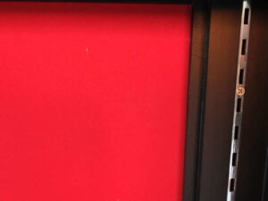 Product shelf Without shelves (black-red), wooden frame, with storage drawers.