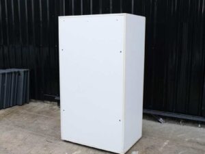 Wooden cabinet with 2 doors, cream color, wavy design.